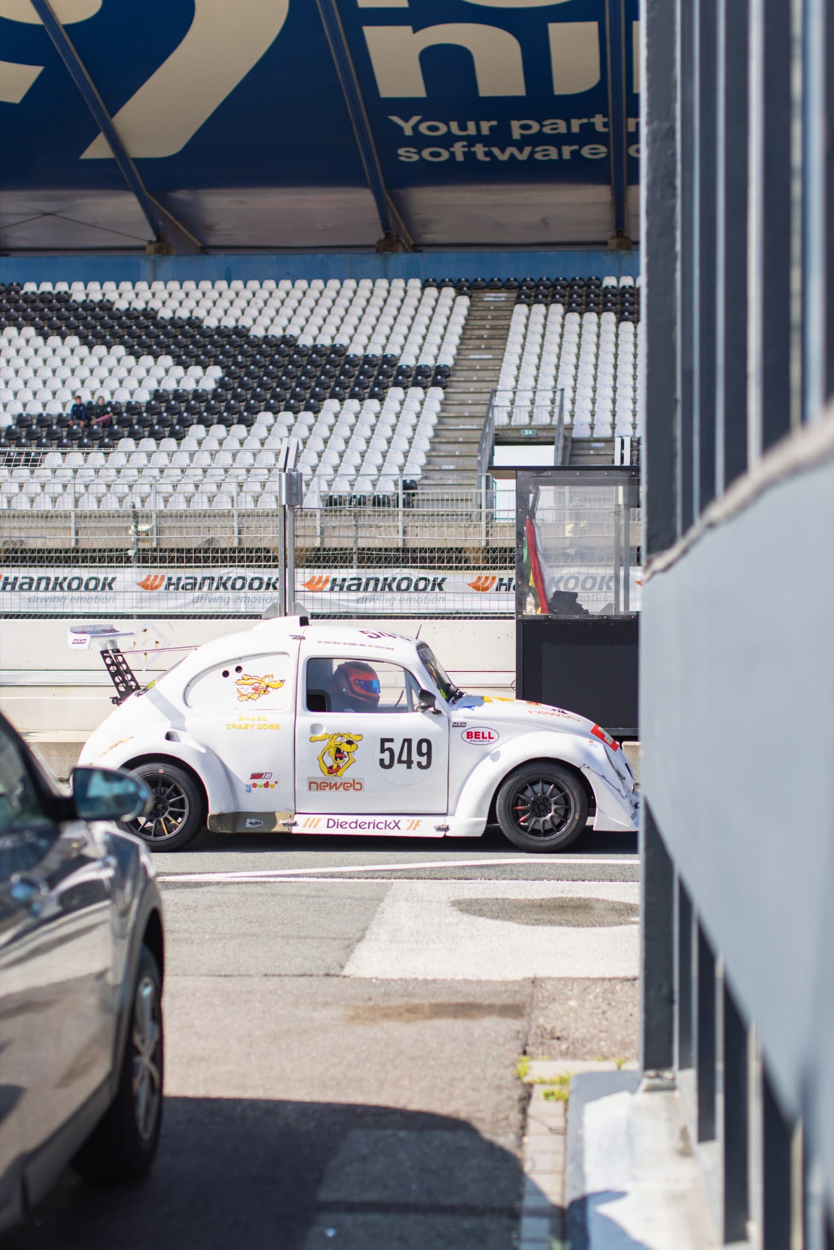 Weißer VW-Käfer-Rennwagen vor der leeren Tribüne am Circuit Zandvoort